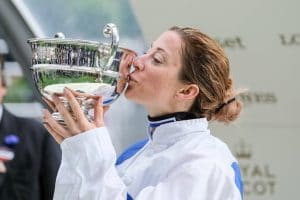 Hayley Turner kisses a trophy after winning a horse race