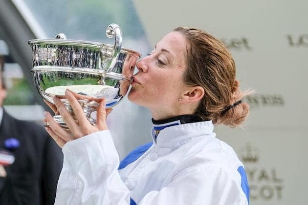 Hayley Turner kisses a trophy after winning a horse race
