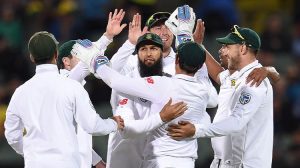 South African cricketers celebrating taking a wicket