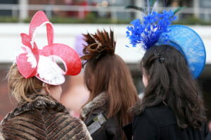 Three ladies with fancy hats at Cheltenham.