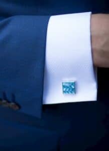 Man's blue cufflink.
