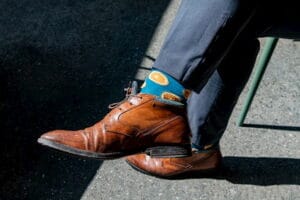 Close up of man wearing colourful socks.