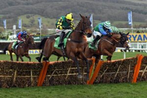 Horses jump a fence at the Stayers' Hurdle