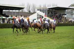 Horses racing past the stand at the Mares' Novices' Hurdle