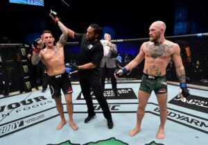Referee raises the hand of Dustin Poirier after he defeated Conor McGregor