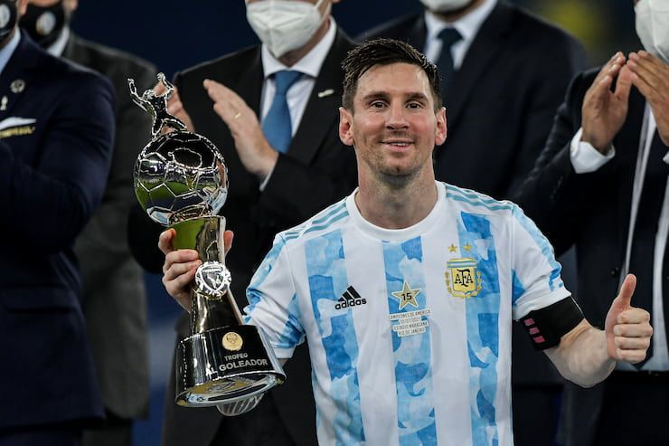 Lionel Messi accepts the Copa America trophy in 2021 after Argentina beat Brazil in the final.