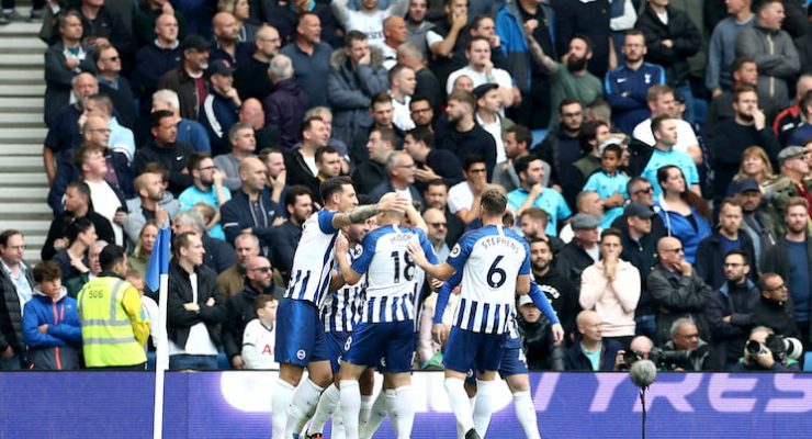 Brighton players celebrate a goal in front of their fans