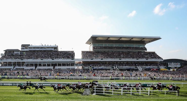 Horses race past the main stand at the Grand National