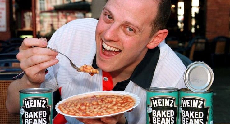 Man eating Heinz baked beans.