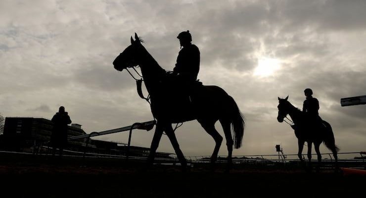 Silhouette of horses at start of Ladies Day, at the Aintree Grand National Festival