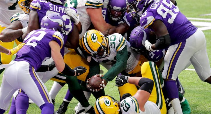 The Green Bay Packers and Minnesota Vikings fight for the ball in an NFL game.