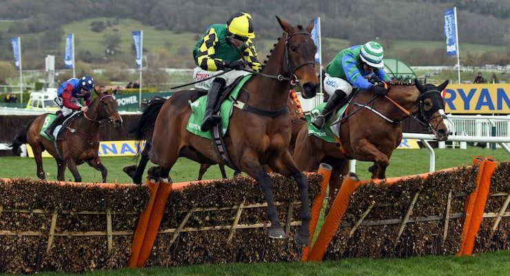 Horses jump a fence at the Stayers' Hurdle